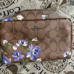 Small makeup bag by coach with beautiful purple flowers